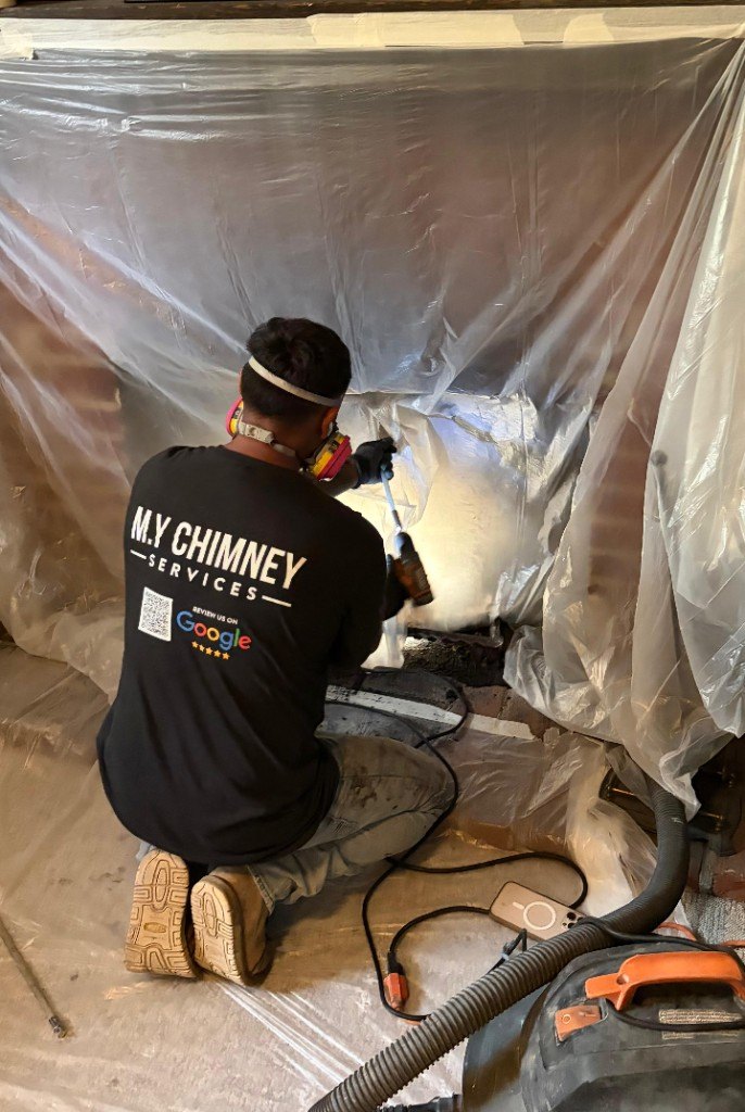 M.Y Chimney technician cleaning a fireplace in Portland, Oregon
