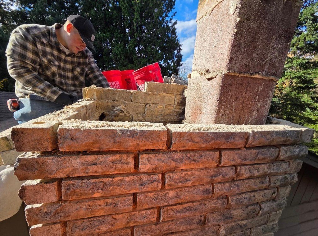 M.Y Chimney mason rebuilding a brick chimney crown in the Portland, Oregon metro