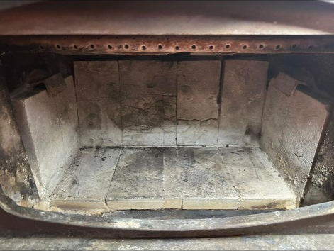 Before: cracked fire bricks needing replacement in a Portland, Oregon firebox